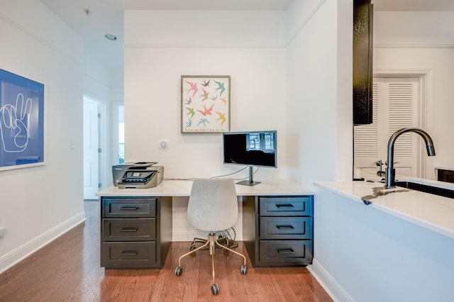 office space featuring light wood-type flooring and sink