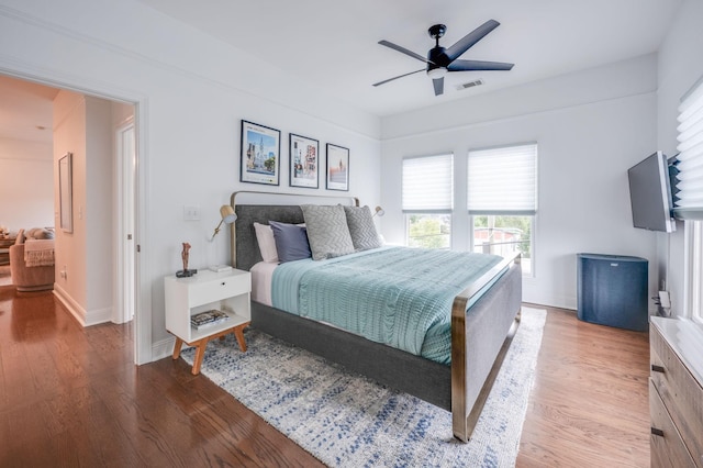 bedroom with hardwood / wood-style floors and ceiling fan