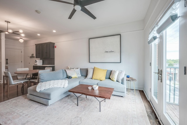 living room featuring ceiling fan, french doors, and light hardwood / wood-style flooring