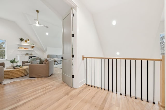 hallway with lofted ceiling and wood finished floors