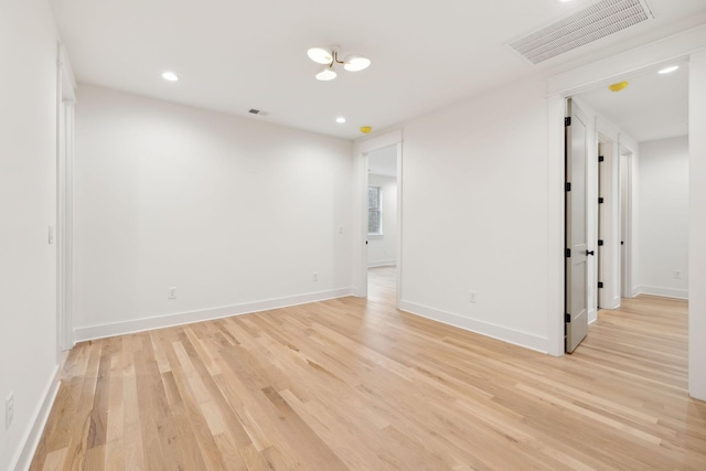 spare room with visible vents, recessed lighting, light wood-type flooring, and baseboards