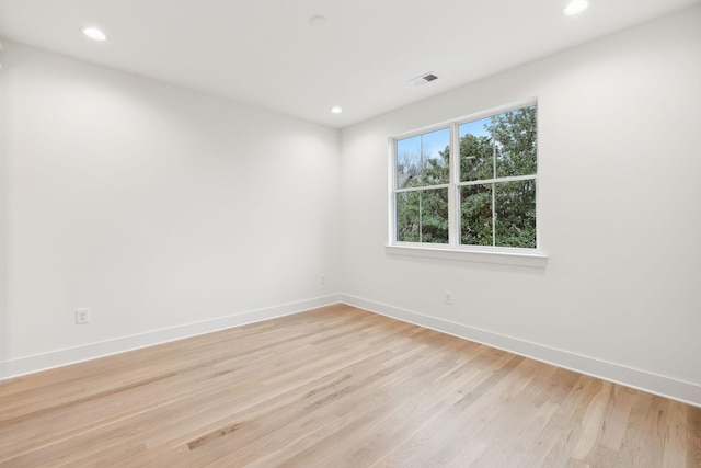 unfurnished room with recessed lighting, baseboards, and light wood-style flooring