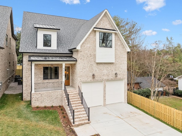 view of front of property with a front yard, a porch, and a garage