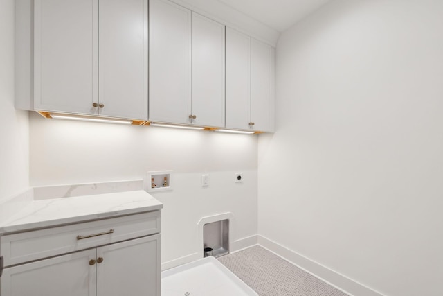 laundry room with cabinet space, hookup for an electric dryer, hookup for a washing machine, and baseboards