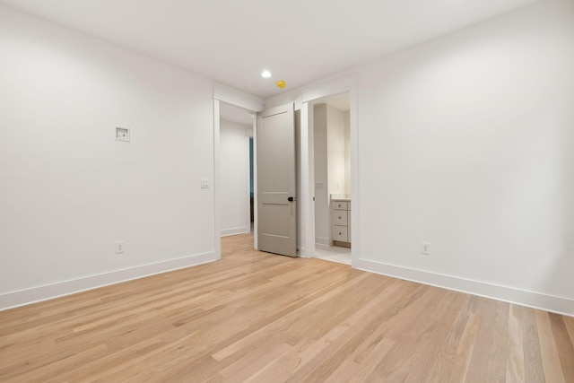 spare room with recessed lighting, baseboards, and light wood finished floors