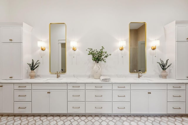 bathroom featuring a sink and double vanity