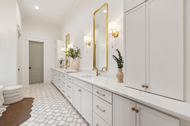 bathroom with a sink, double vanity, recessed lighting, and crown molding