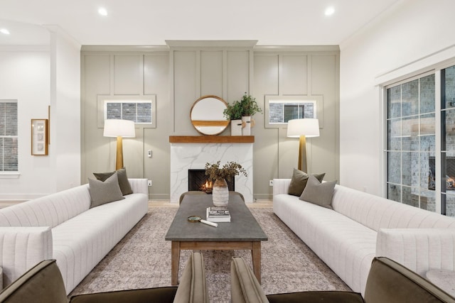 living area with recessed lighting, baseboards, and a premium fireplace