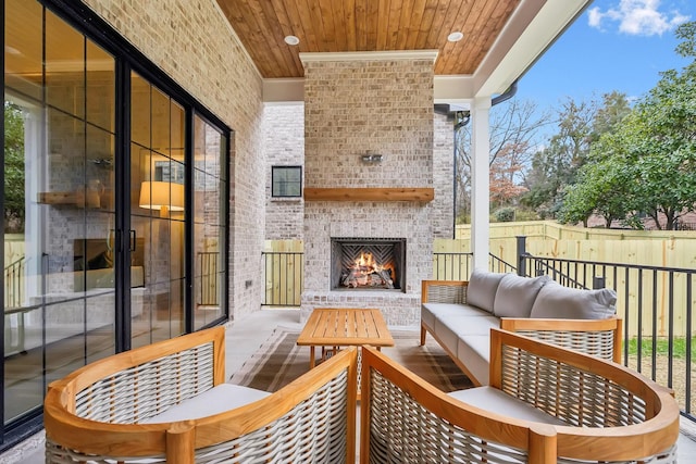 exterior space with fence and an outdoor living space with a fireplace