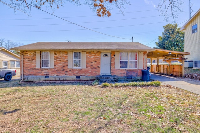 view of front of house with brick siding, concrete driveway, an attached carport, crawl space, and a front yard