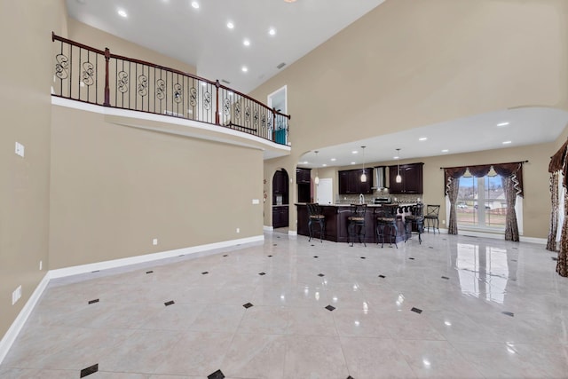 unfurnished living room with a high ceiling