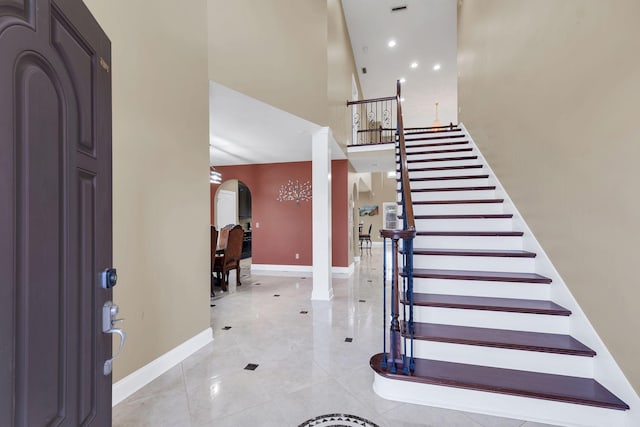 foyer with light tile patterned floors and a high ceiling