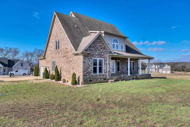 view of front facade with covered porch, a garage, and a front lawn