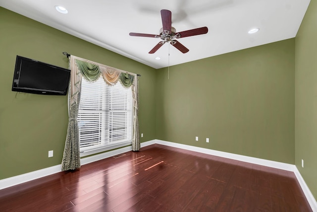 empty room with hardwood / wood-style floors and ceiling fan