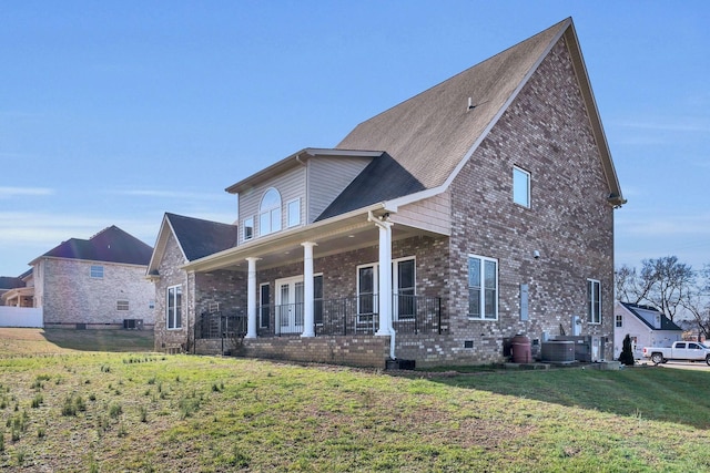 view of front of property featuring a porch, a front lawn, and cooling unit