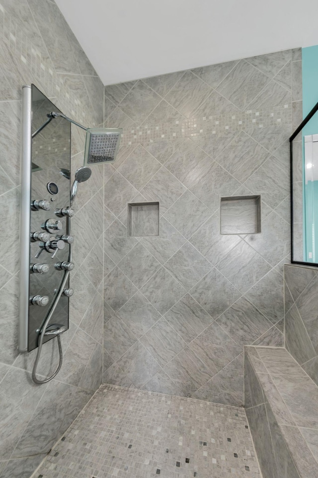 bathroom with tiled shower