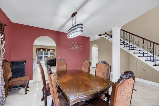 dining space with a chandelier and light tile patterned floors