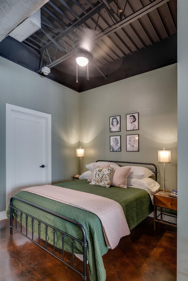 bedroom with ceiling fan and concrete floors