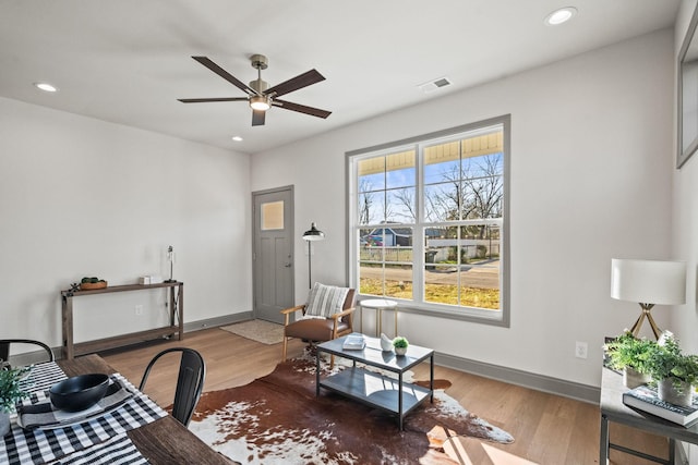 living room featuring hardwood / wood-style flooring and ceiling fan