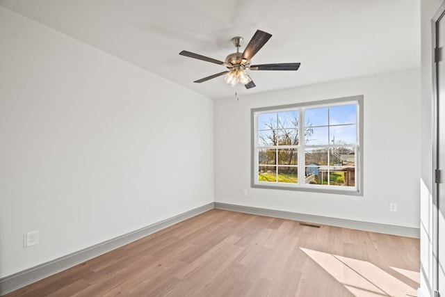 empty room with light hardwood / wood-style flooring and ceiling fan