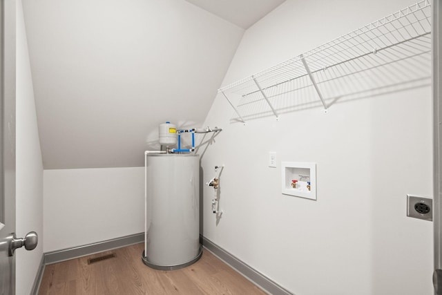 laundry area featuring electric dryer hookup, wood-type flooring, hookup for a washing machine, and water heater