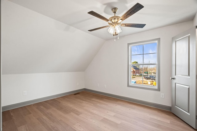 additional living space with ceiling fan, lofted ceiling, and light hardwood / wood-style flooring