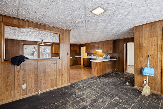 kitchen with wooden walls and kitchen peninsula