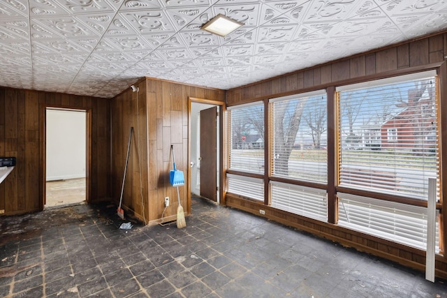 interior space with wooden walls and a healthy amount of sunlight