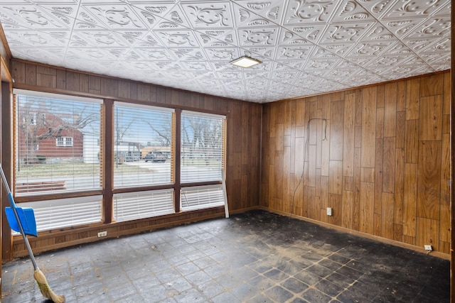 spare room featuring wooden walls