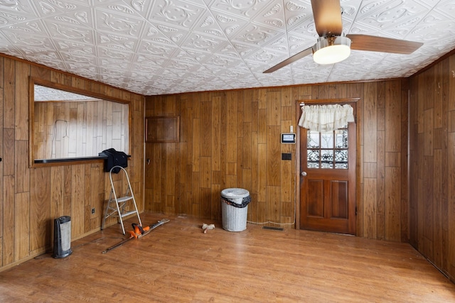 foyer featuring hardwood / wood-style flooring and wooden walls