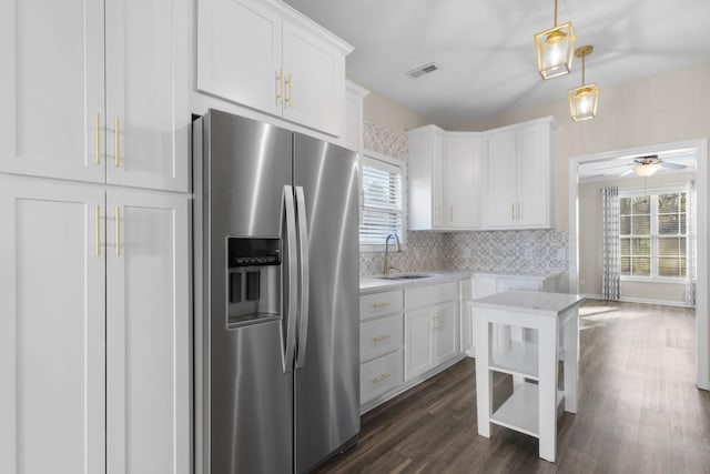 kitchen with white cabinetry, stainless steel fridge with ice dispenser, sink, and ceiling fan