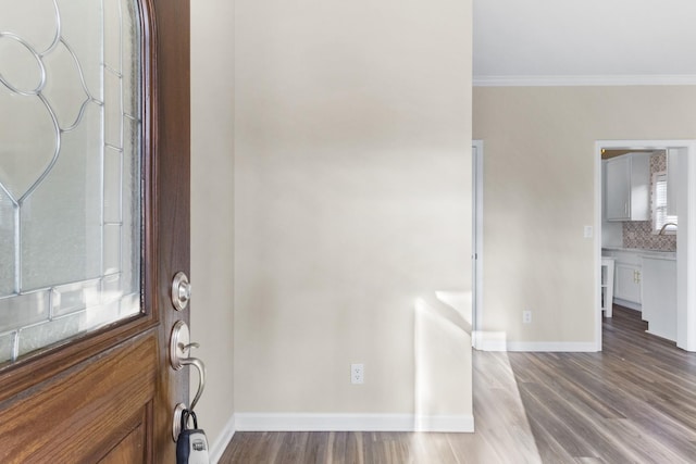 entryway featuring crown molding and light hardwood / wood-style flooring