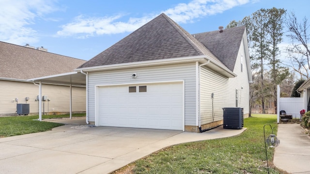 view of home's exterior with a yard, a garage, a carport, and central air condition unit