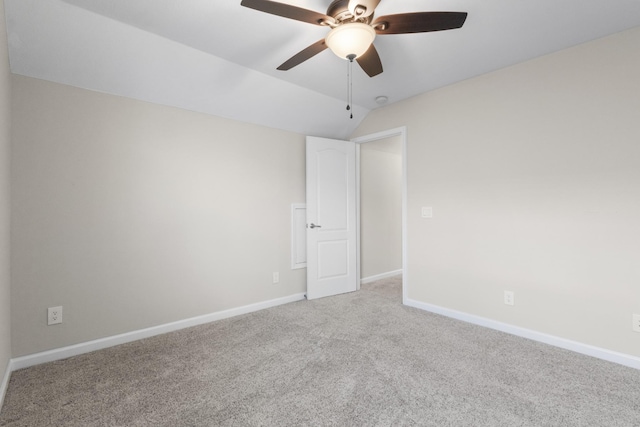 unfurnished room featuring light colored carpet, vaulted ceiling, and ceiling fan