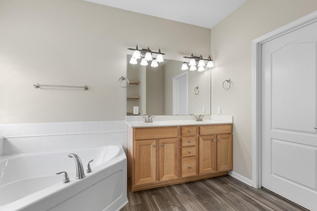 bathroom featuring a tub to relax in, vanity, and hardwood / wood-style flooring