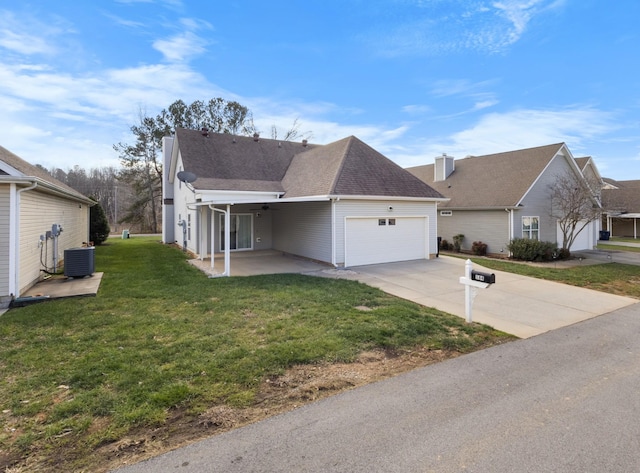 view of front of house featuring a front yard, a garage, and central air condition unit