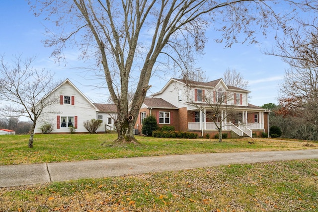 view of front of house with covered porch and a front yard