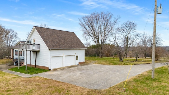 view of property exterior with a yard, a garage, and a deck