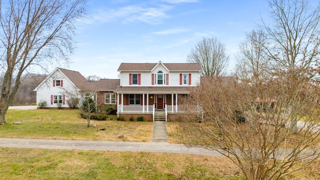 view of front facade with covered porch and a front yard