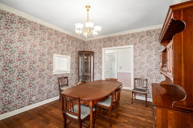 dining room with dark wood-type flooring, a notable chandelier, and ornamental molding