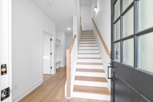 stairway with hardwood / wood-style flooring