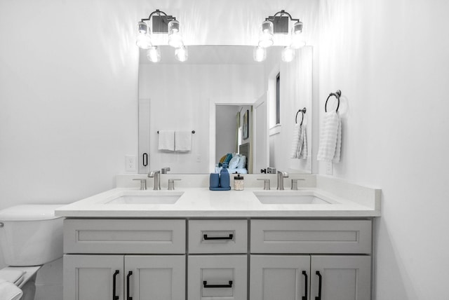 bathroom featuring vanity and toilet