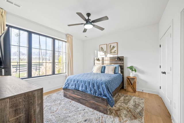 bedroom with ceiling fan and light hardwood / wood-style flooring