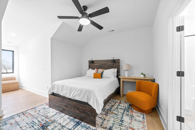 bedroom featuring light hardwood / wood-style floors, ceiling fan, and lofted ceiling