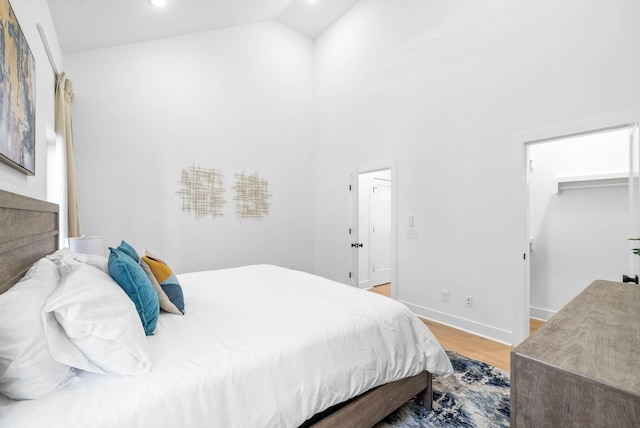 bedroom with light hardwood / wood-style flooring and vaulted ceiling