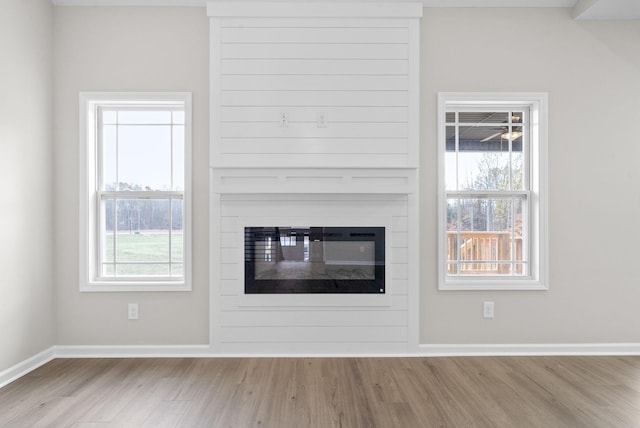 unfurnished living room with a fireplace and light hardwood / wood-style flooring