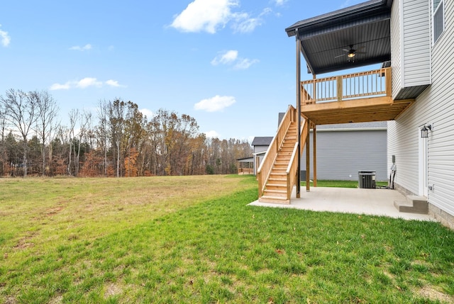 view of yard with ceiling fan, a patio, central AC unit, and a deck