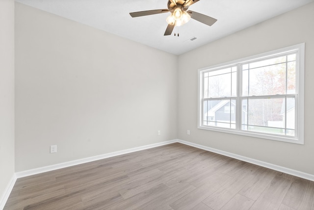 spare room featuring ceiling fan and light hardwood / wood-style flooring