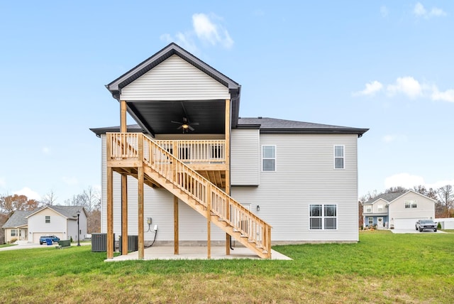 rear view of property featuring a patio, ceiling fan, a wooden deck, and a lawn