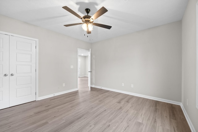 unfurnished bedroom with ceiling fan, a closet, and light hardwood / wood-style floors